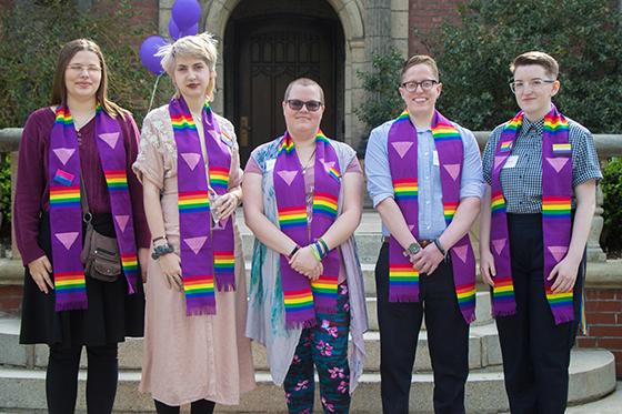 Photo of a group of Chatham University students wearing graduation stoles with rainbow LGBTQ+ representation, 一起摆姿势拍照. 